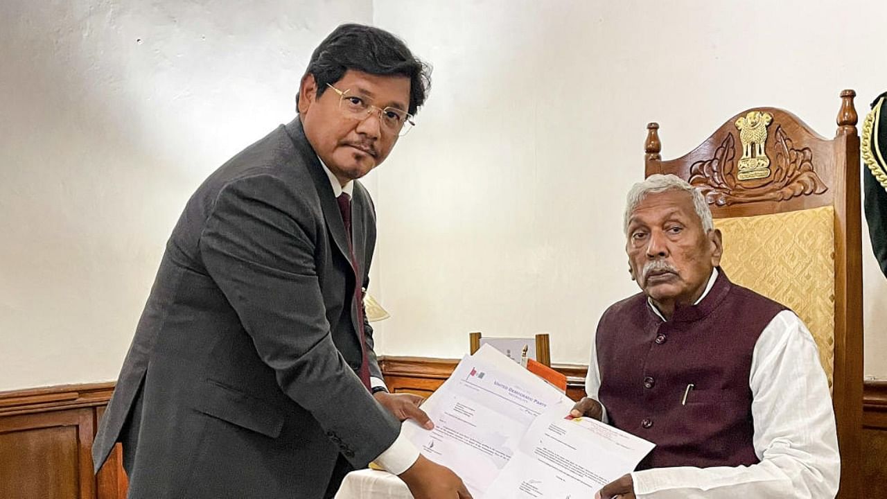 Meghalaya Governor Phagu Chauhan receives the letter of support from NPP leader Conrad Sangma to form government in state. Credit: PTI Photo