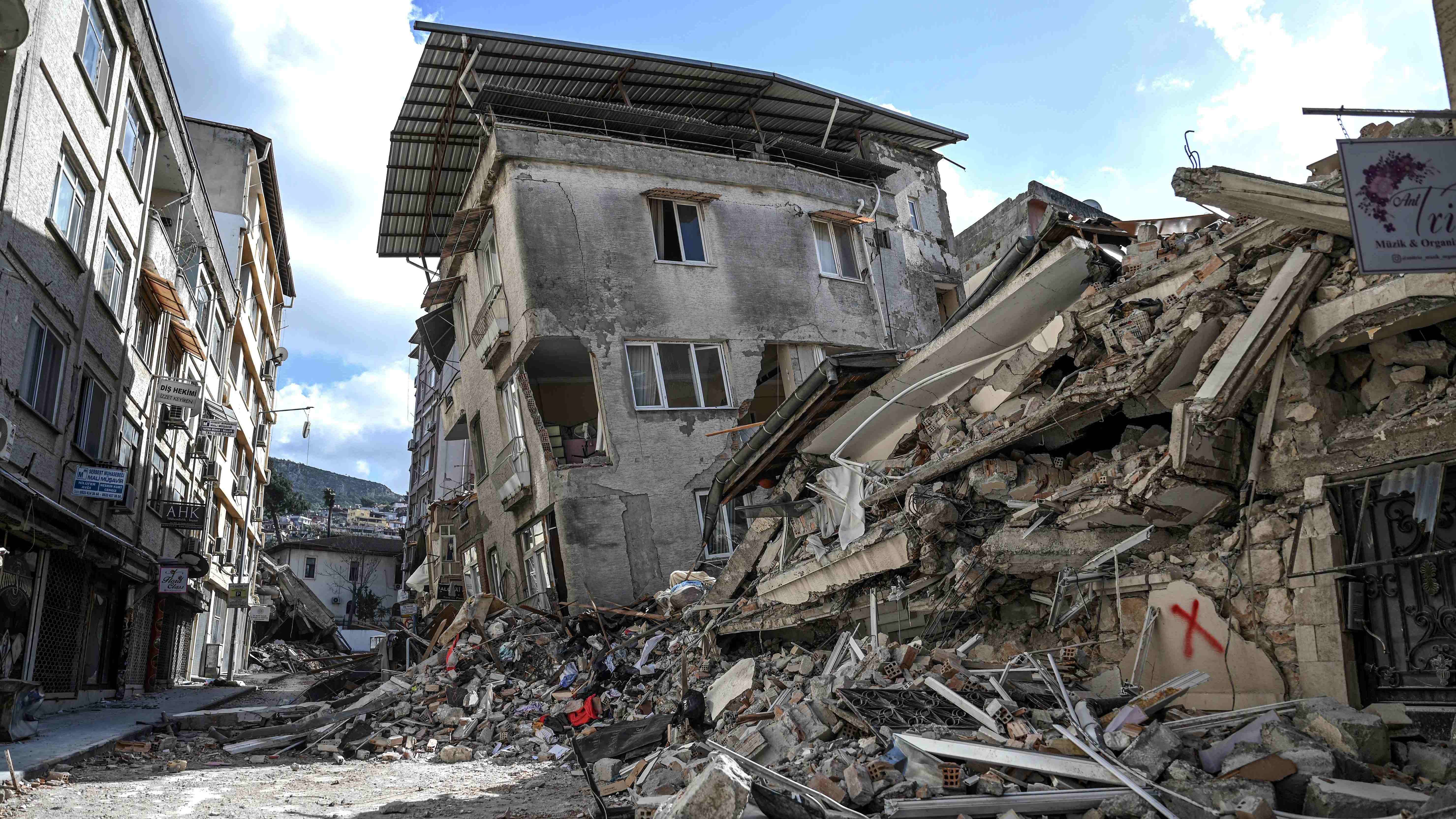 This picture shows collapsed buildings in Hatay on March 6, 2023, one month after a massive earthquake struck southeastern Turkey.  Credit: AFP Photo