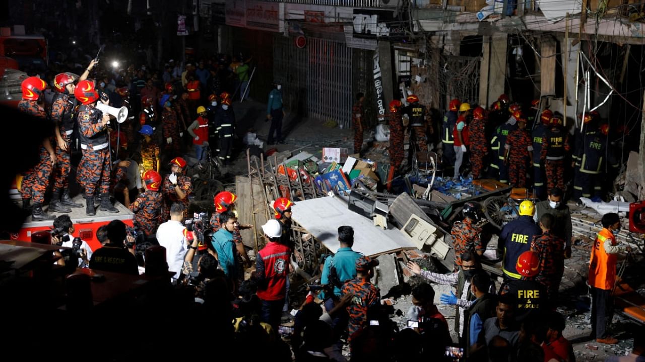 Firefighters and rescue workers are seen on the site of an explosion in a multi storey building in Dhaka. Credit: Reuters Photo