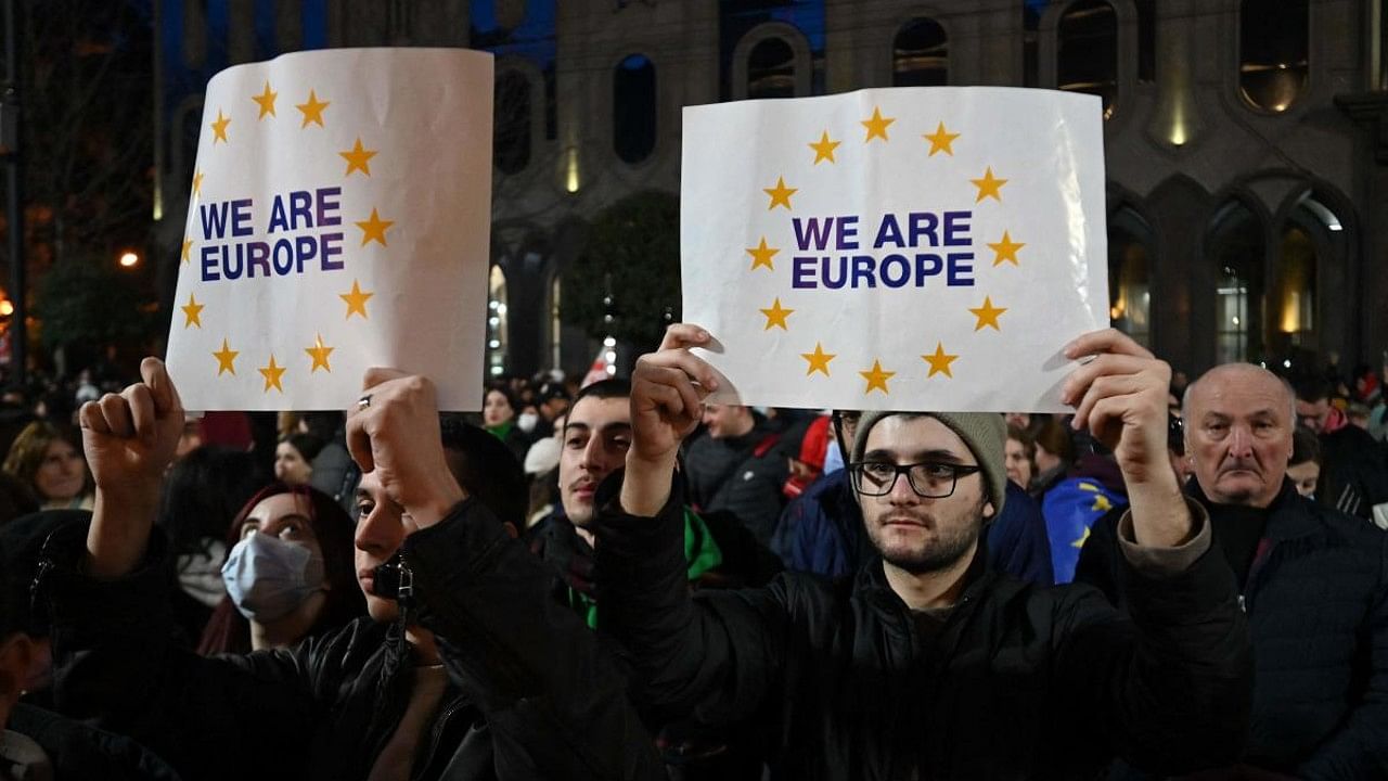 Protesters hold placard during a demonstration called by Georgian opposition and civil society groups outside Georgia's Parliament in Tbilisi. Credit: AFP Photo