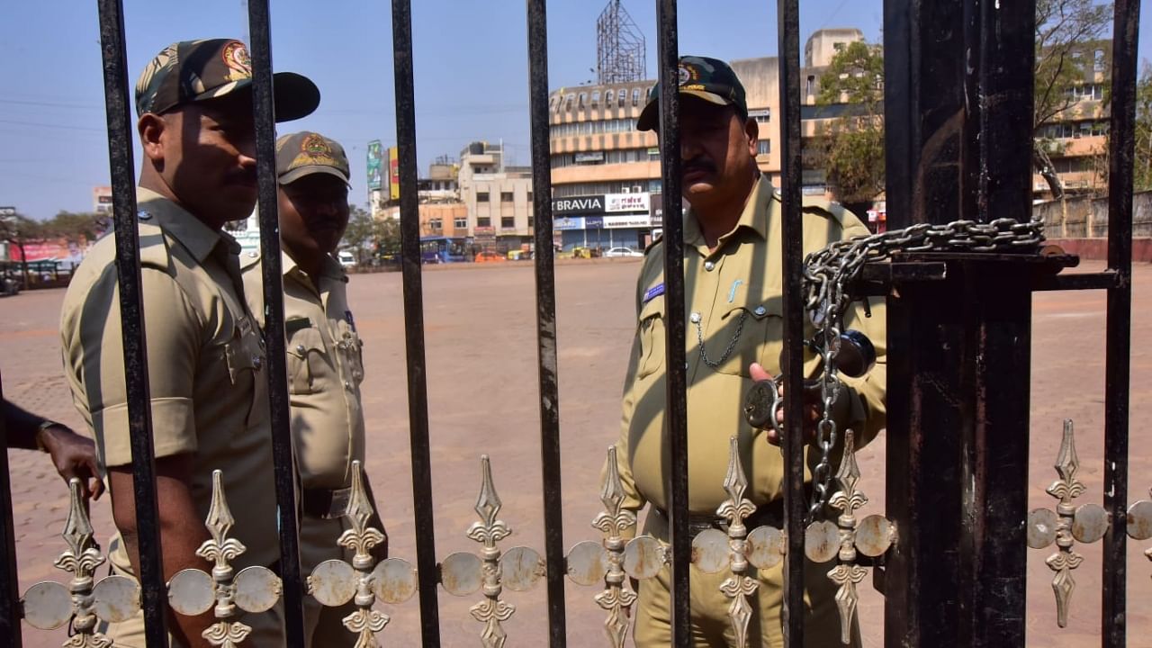 Policeman stand guard near the locked gate of Idgah Maidan near Chennamma Circle in Hubballi on Thursday. Credit: DH Photo