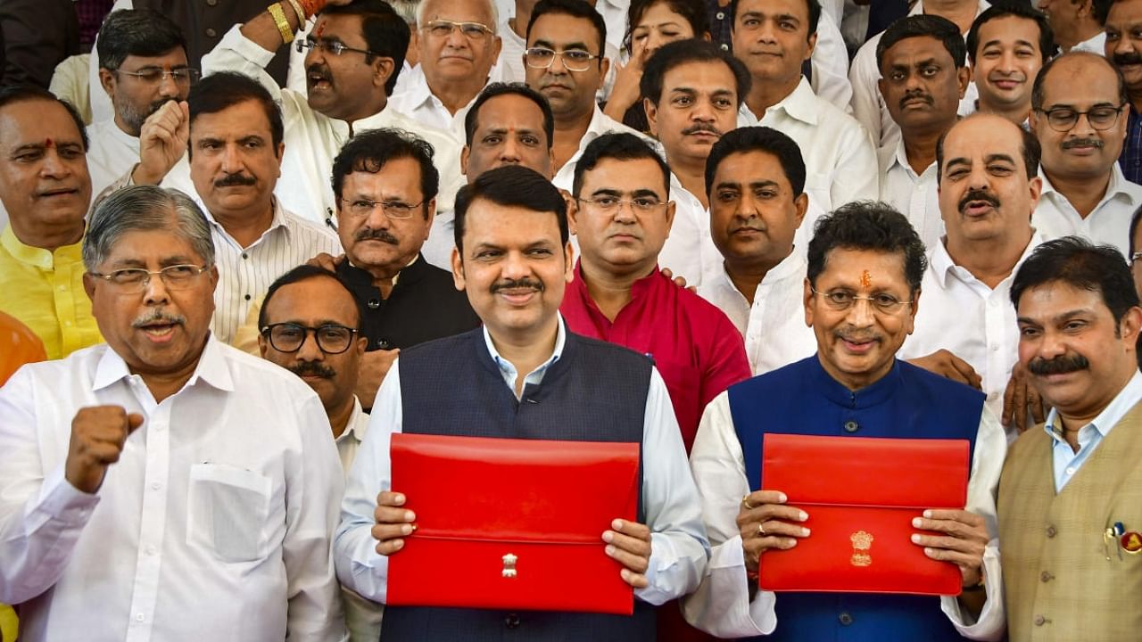 Maharashtra Deputy CM and Finance Minister Devendra Fadnavis with the state Budget. Credit: PTI Photo
