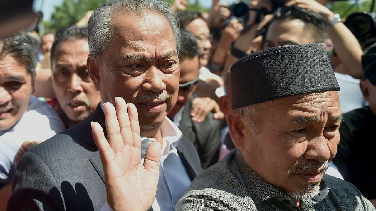 Former prime minister of Malaysia and Perikatan Nasional (PN) chairman Muhyiddin Yassin waves as he arrives at the Malaysian Anti-Corruption Commission (MACC) headquarters to give a statement over allegations that his party misused public funds meant to fight Covid-19 in Putrajaya. Credit: AFP Photo