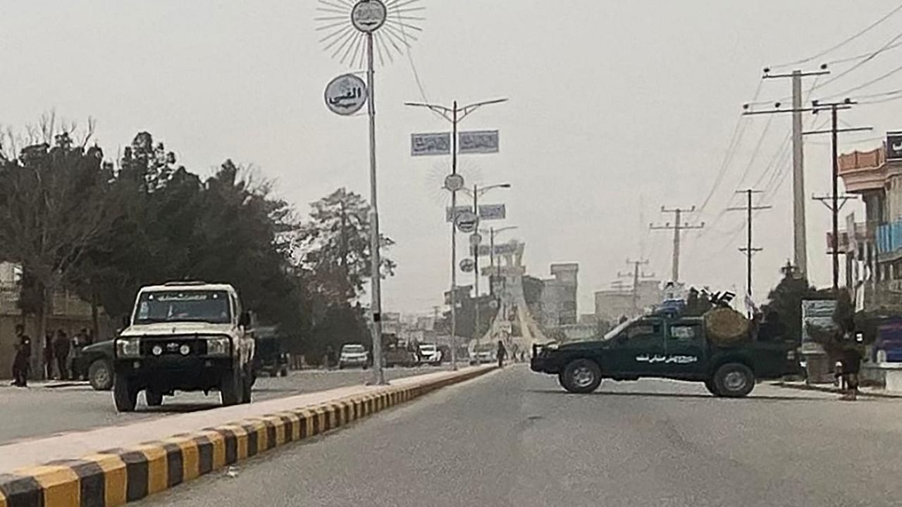 Taliban security personnel (R) block a road in Mazar-i-Sharif on March 9, 2023, following a blast at the office of Taliban governor of Afghanistan's Balkh province. Credit: AFP  Photo