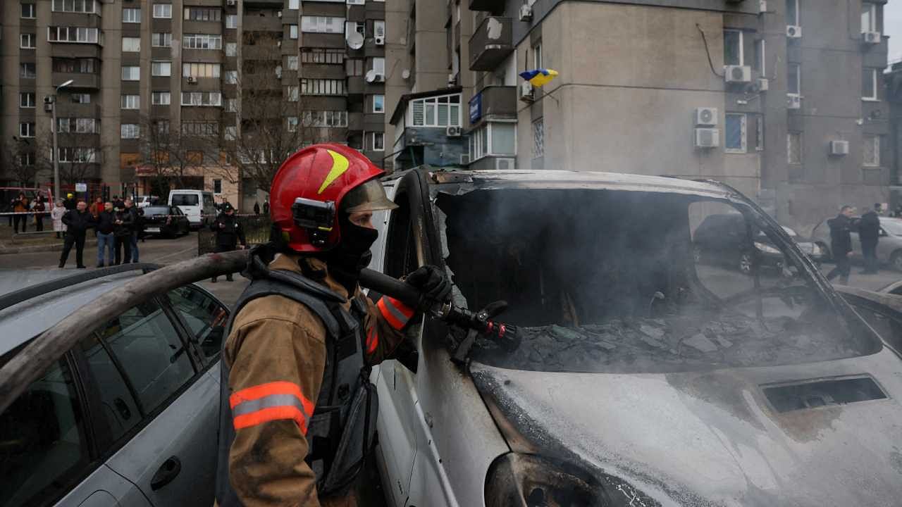Emergency workers extinguish fire in vehicles at the site of a Russian missile strike, amid Russia’s attack on Ukraine. Credit: Reuters Photo
