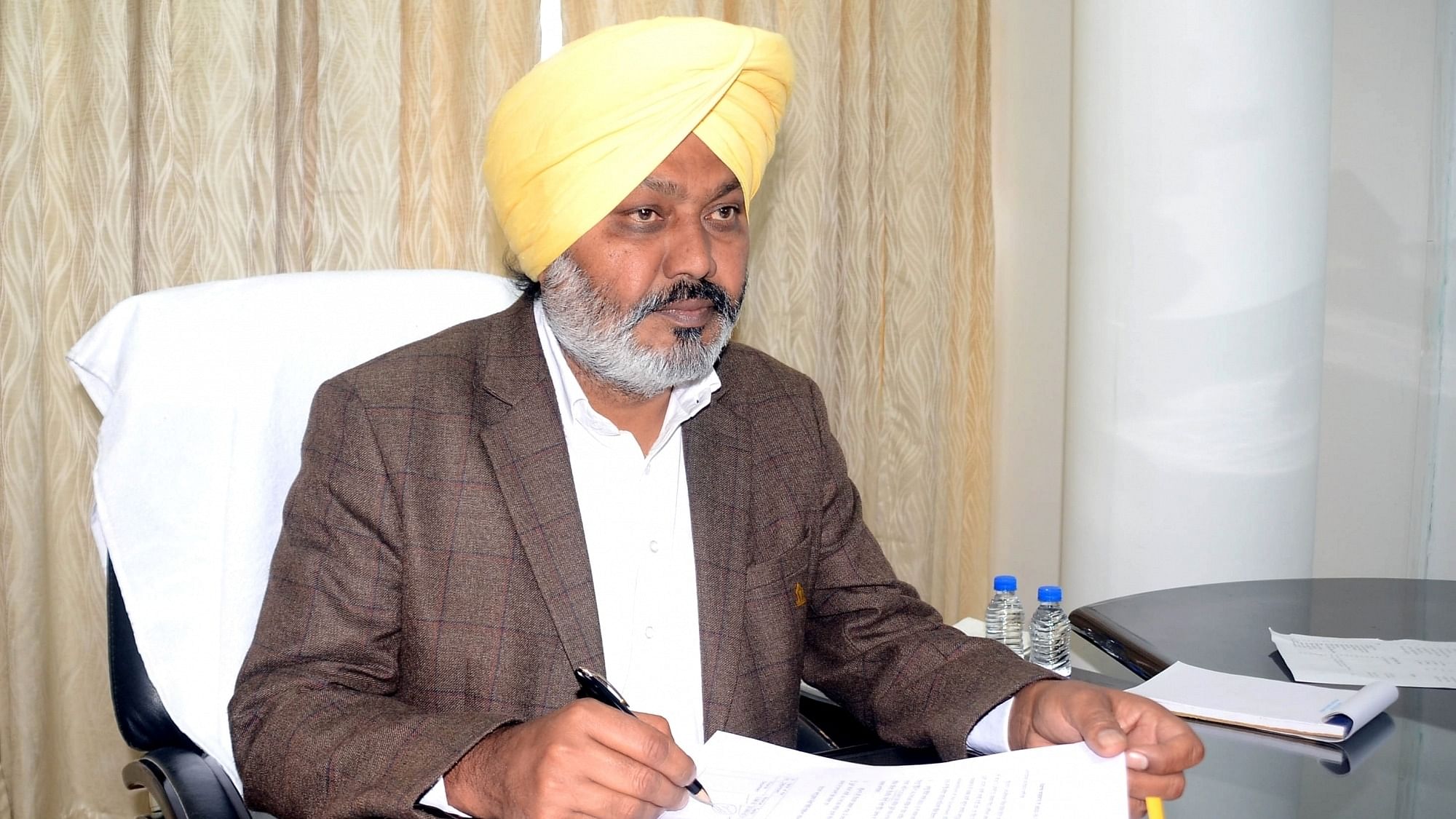 Punjab Finance Minister Harpal Singh Cheema signs budget copies ahead of the state budget in Chandigarh On Thursday, March 09, 2023. Credit: IANS Photo