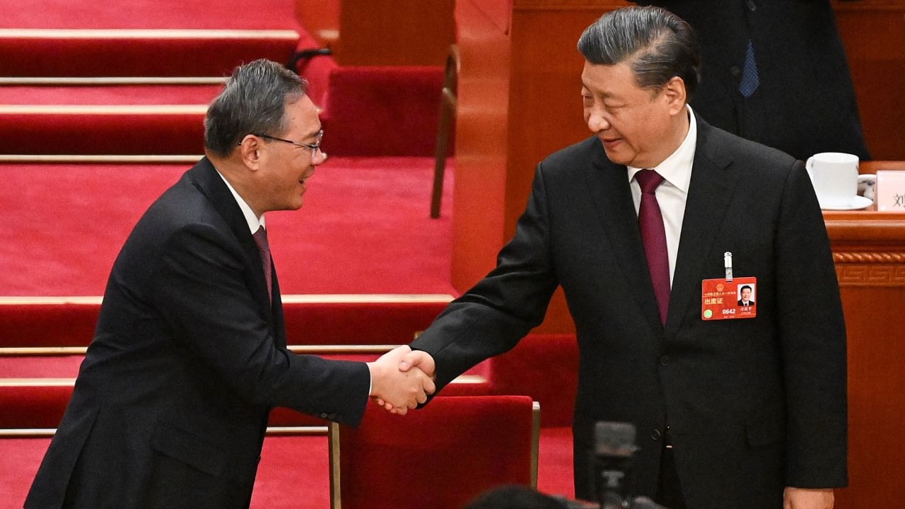 China's President Xi Jinping (R) with new Premier Li Qiang (L), during the third plenary session of the National People's Congress (NPC) in Beijing on March 10, 2023. Credit: AFP Photo