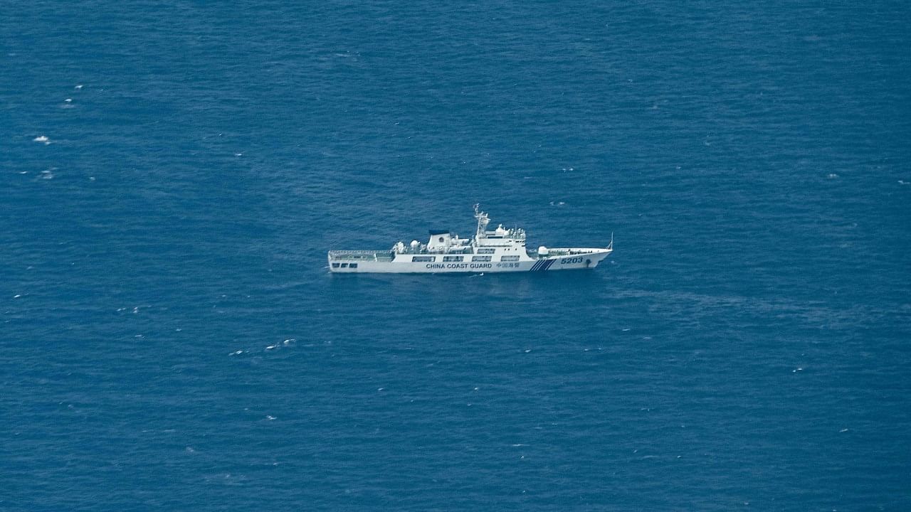 An aerial view taken on March 9, 2023 shows a vessel identified by the Philippine Coast Guard as a Chinese coast guard ship near Thitu Island in the South China Sea. Credit: AFP Photo