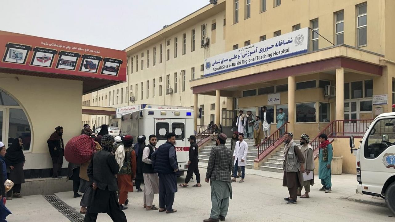 People stand outside a hospital after a bomb blast in Mazar-e Sharif, the capital city of Balkh province, in northern Afghanistan. Credit: AP/PTI