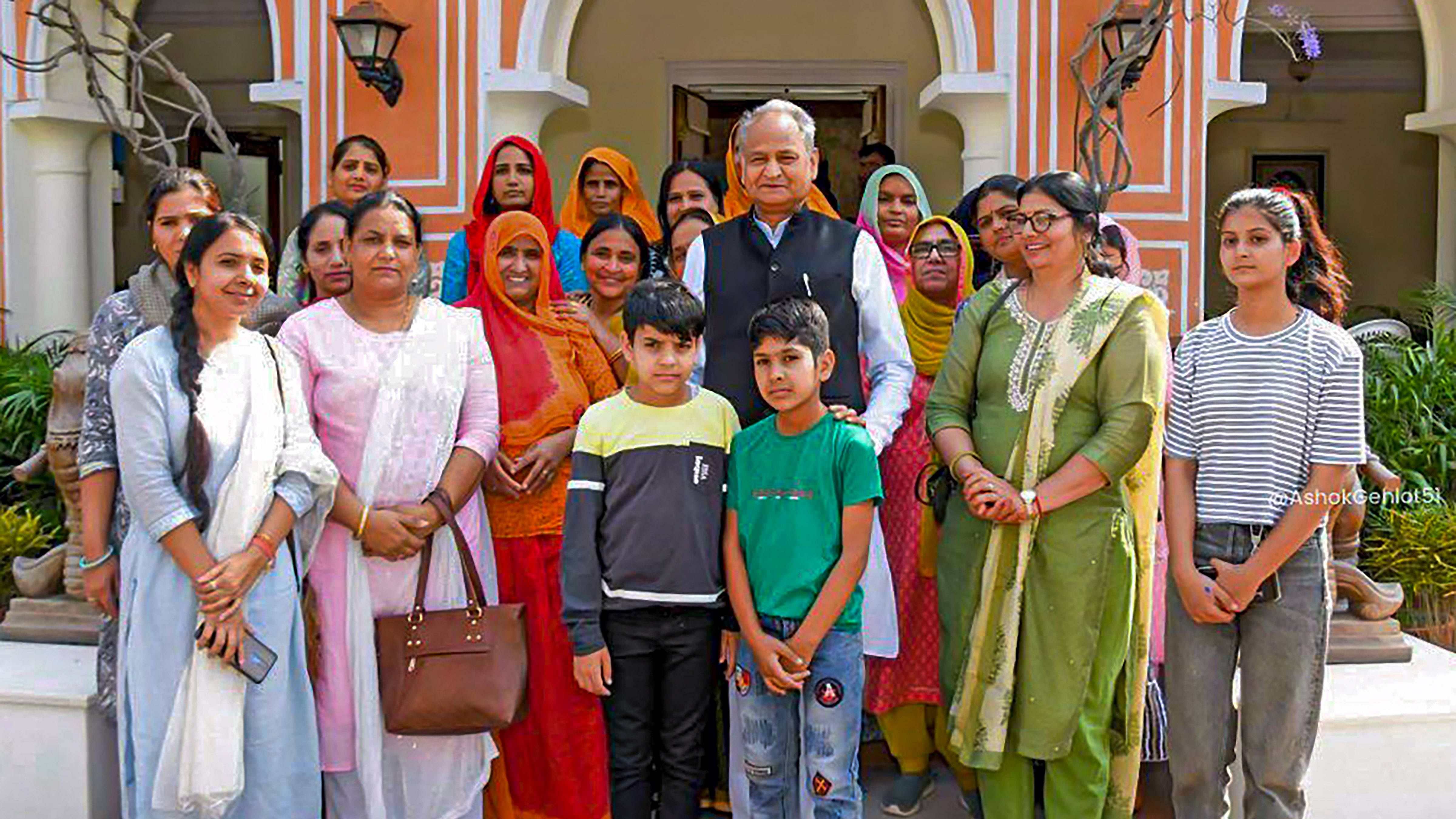 Rajasthan CM Ashok Gehlot in a group photo with the family members of martyrs, in Jaipur. Credit: PTI Photo