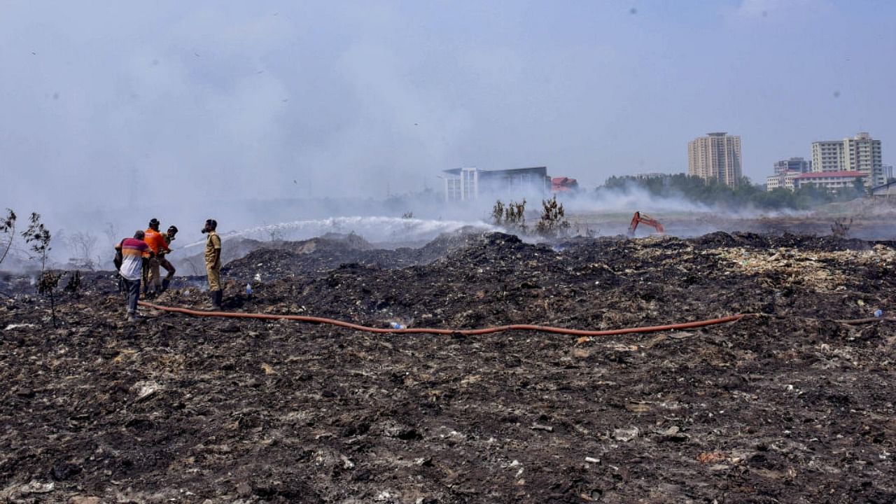  Fire and rescue personnel at the Brahmapuram waste treatment plant. Credit: PTI File Photo