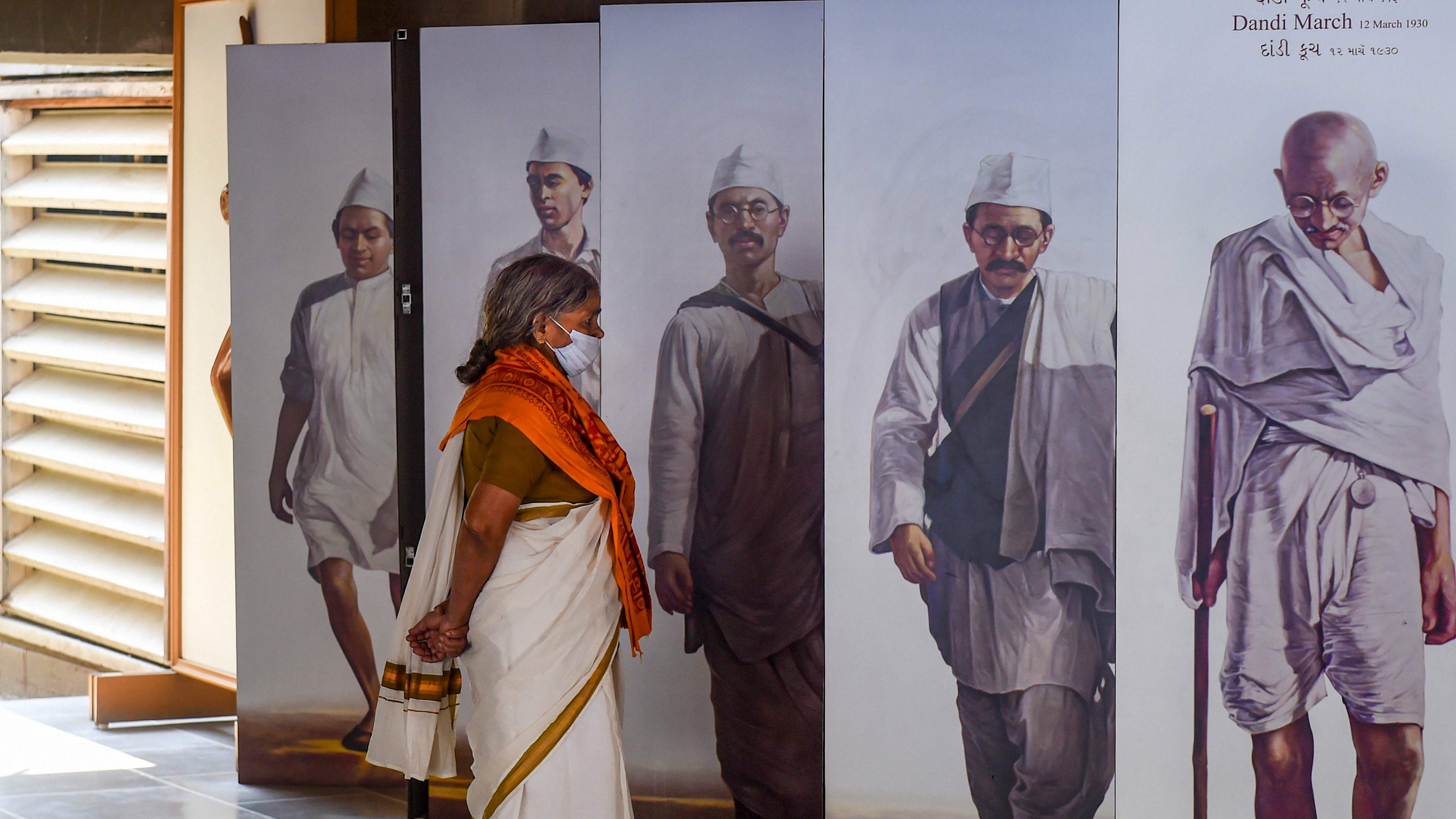  A visitor looks at photographs of the 'Dandi March' at a museum inside the Sabarmati Ashram, in Ahmedabad. Credit: PTI Photo