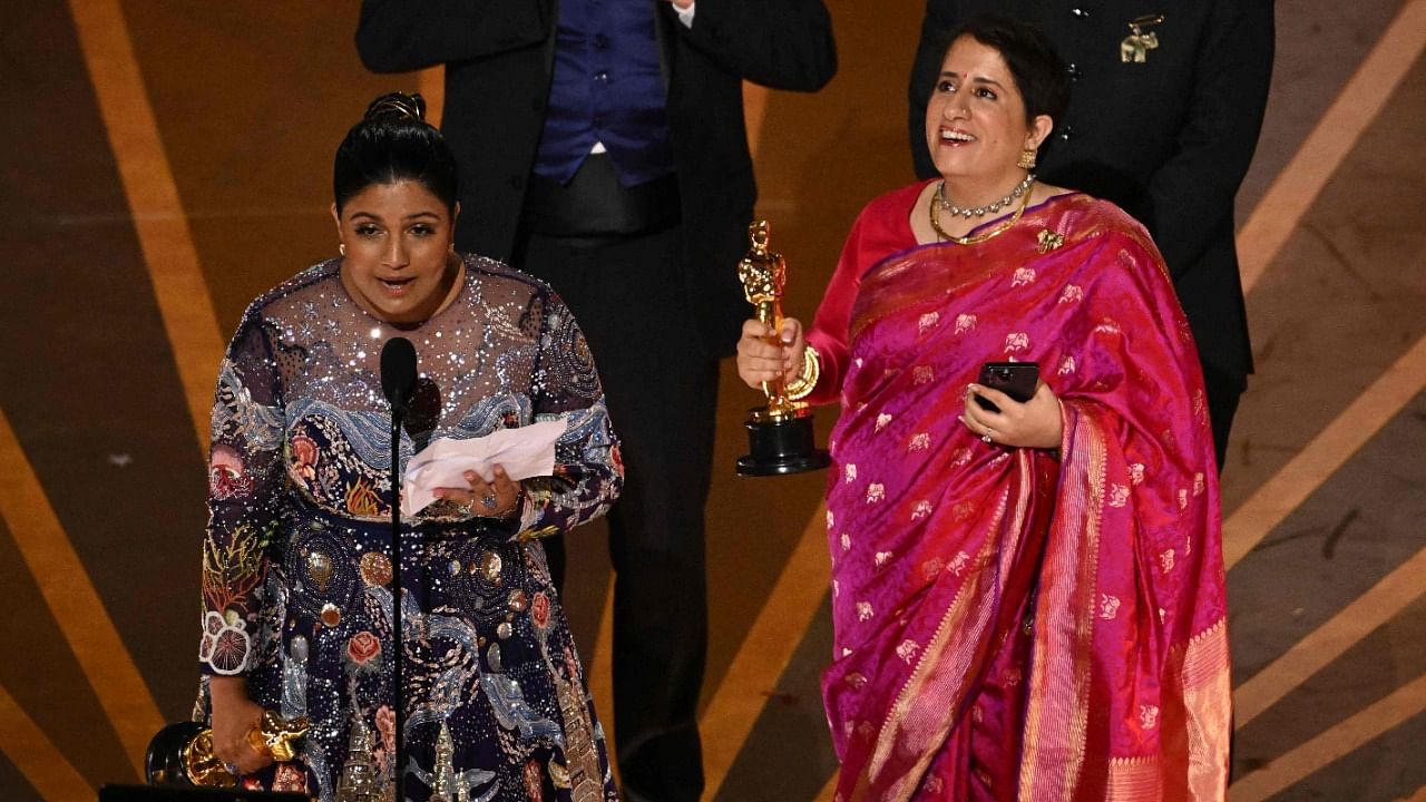 Indian filmmaker Kartiki Gonsalves (L) and Indian film producer Guneet Monga (R) accept the Oscar for Best Short Subject Documentary for "The Elephant Whisperers". Credit: AFP Photo