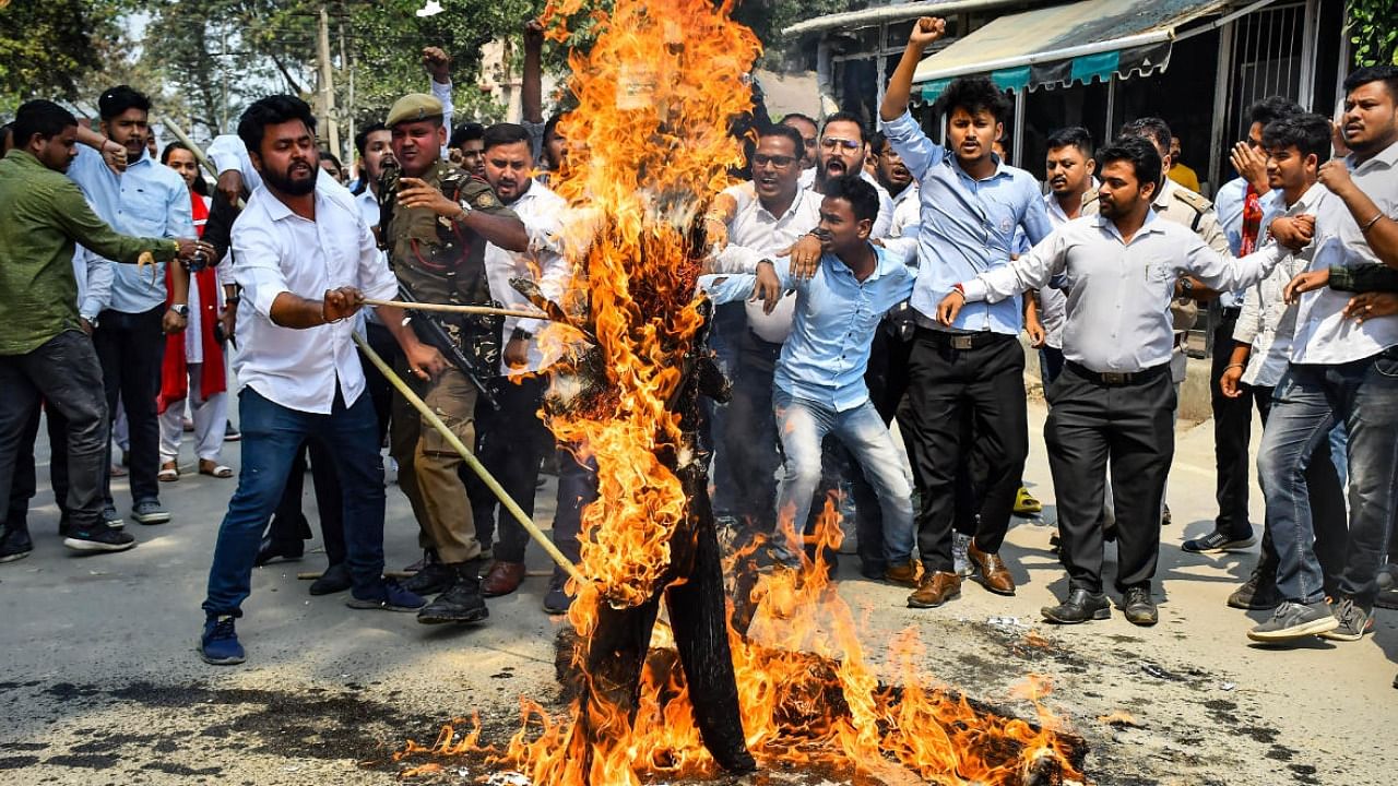  Activists of All Assam Students' Unions (AASU) burn an effigy during a protest following the cancellation of a 10th standard science exam after question paper leak, in Guwahati. Credit: PTI Photo