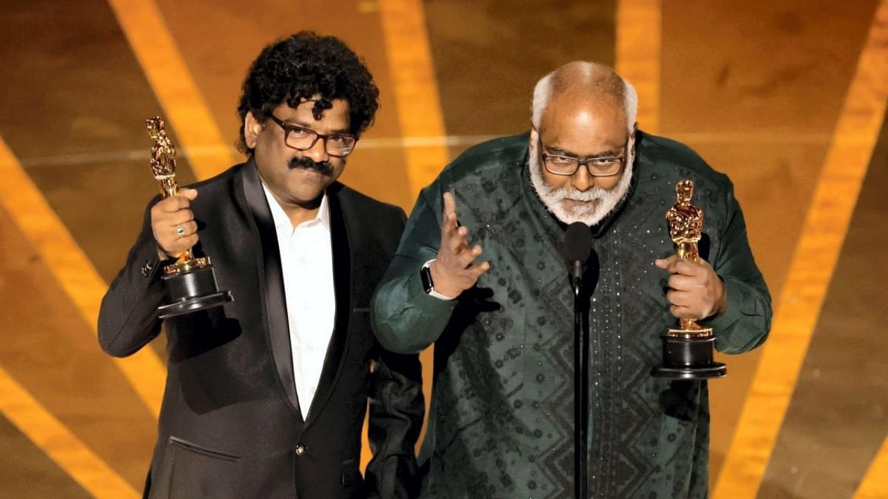 Music composer M.M. Keeravaani and lyricist Chandrabose accept the award for best original song for 'Naatu Naatu' from film 'RRR' at the Oscars 2023, in Los Angeles, USA, Sunday, March 12, 2023. Credit: PTI Photo