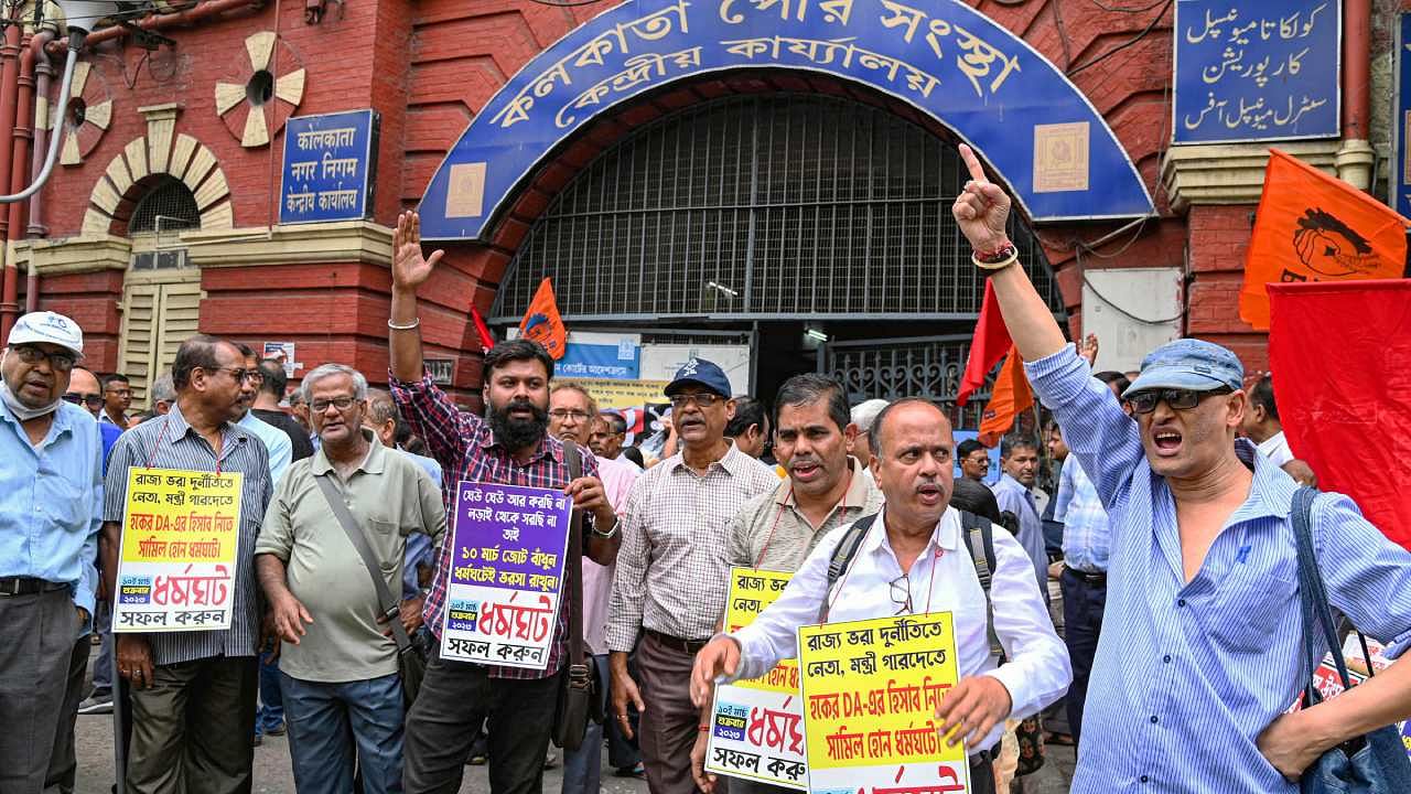 West Bengal Government employees raise slogans during their strike demanding clearance of their pending DA, at Kolkata Municipal Corporation headquarters in Kolkata. Credit: PTI Photo