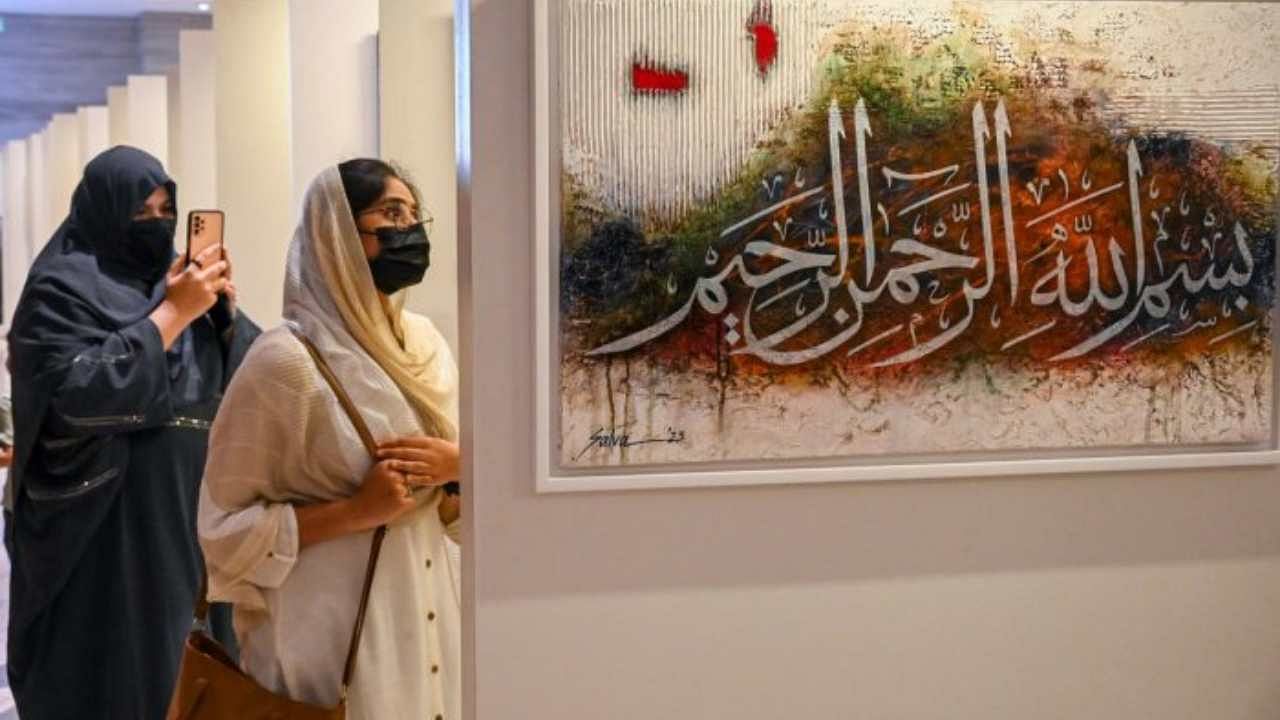 Visitors at the calligraphy exhibition in Bengaluru on Sunday. DH Photo/Pushkar V