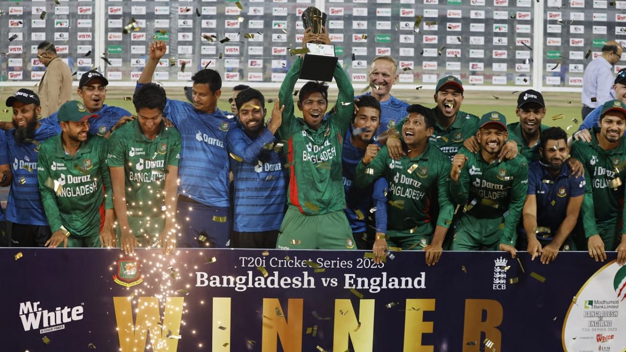 Bangladesh players celebrate with the trophy after winning the series. Credit: Reuters Photo