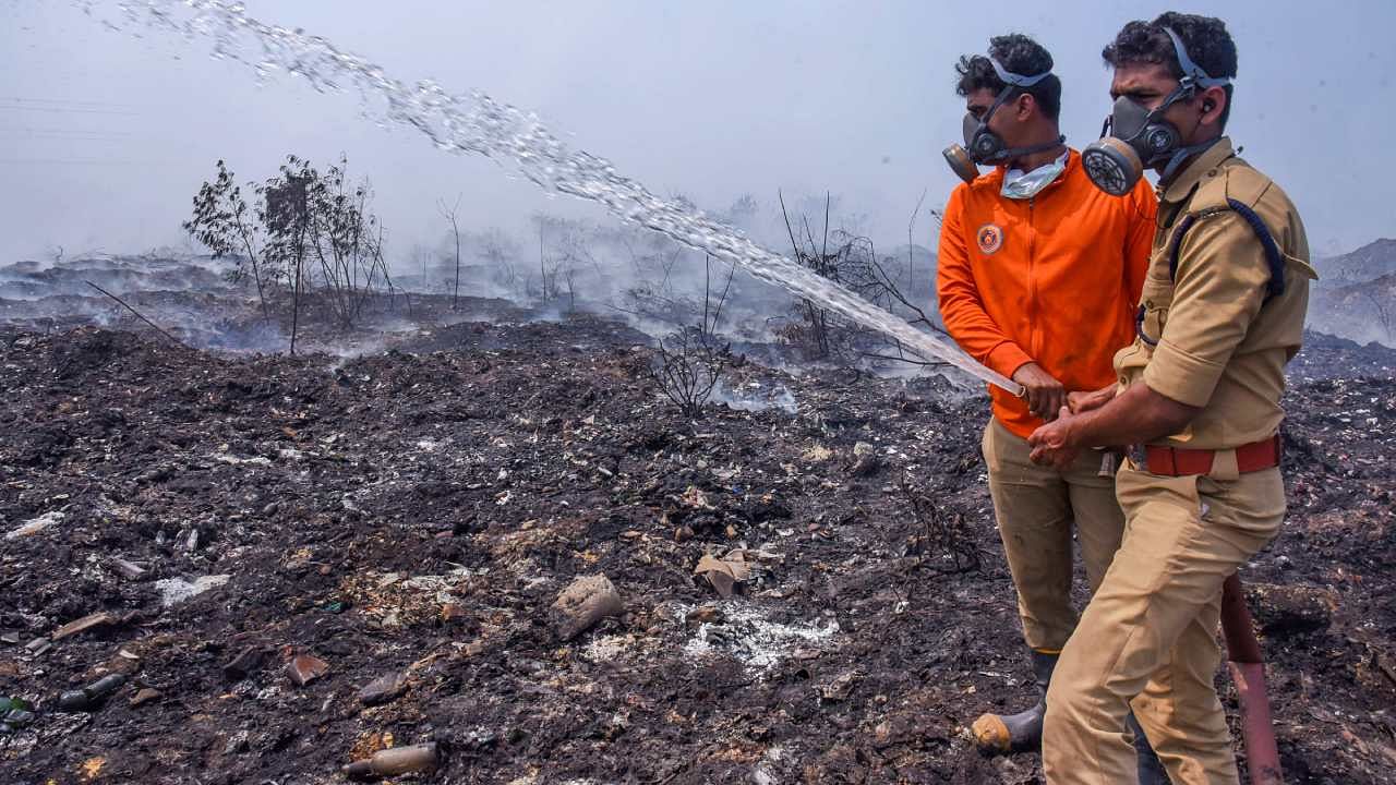 Fire and rescue personnel try to put out the fire which broke out at the Brahmapuram waste treatment plant. Credit: PTI File Photo