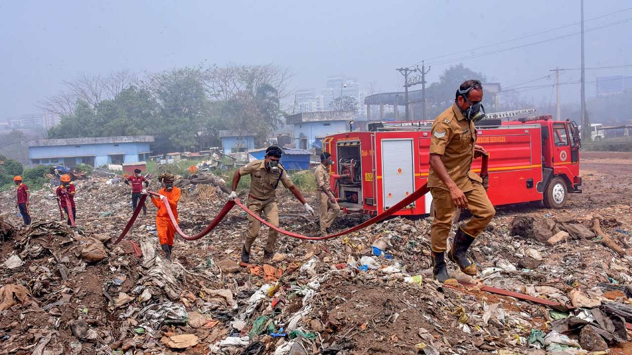 Fire and rescue personnel try to put out the fire which broke out at the Brahmapuram waste treatment plant, in Kochi. Credit: PTI File Photo
