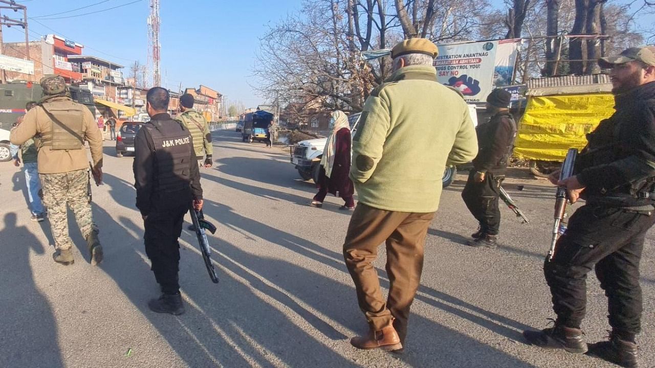 Security personnel during a raid conducted by National Investigation Agency (NIA) in connection with terror-funding cases, in Anantnag district, Tuesday, March 14, 2023. Credit: PTI Photo