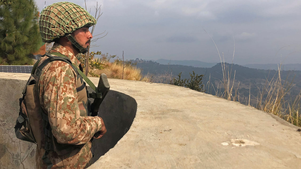 A Pakistan's army soldier stands guard on the Line of Control (LoC) at Abdullah Pur village in Bhimber district of Pakistani-controlled Kashmir. Credit: AFP Photo