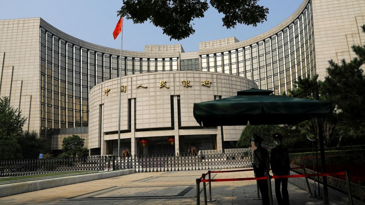 Paramilitary police officers stand guard in front of the headquarters of the People's Bank of China, the central bank (PBOC), in Beijing, China September 30, 2022. Credit: Reuters Photo