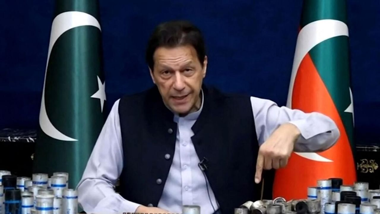 This screengrab from Pakistan Tehreek-e-Insaf via AFPTV taken on March 15, 2023 shows former Pakistan prime minister Imran Khan issuing a video statement with a display of spent teargas canisters that he claims were fired into his home in Lahore. Credit: AFP Photo