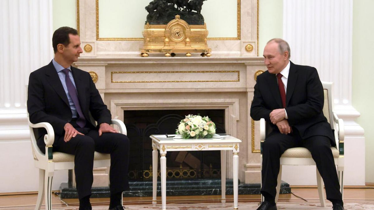Russian President Vladimir Putin, right, and Syrian President Bashar Assad talk during their meeting. Credit: AP/PTI