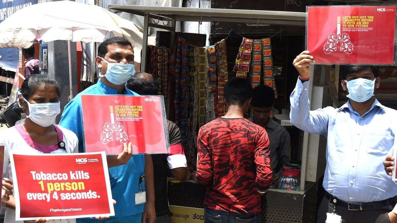 To mark the world No Tobacco day members of the HCG holding a silent protest against harmful effects of tobacco at MG Road-Brigade junction in Bengaluru on Friday. Credit: DH File Photo