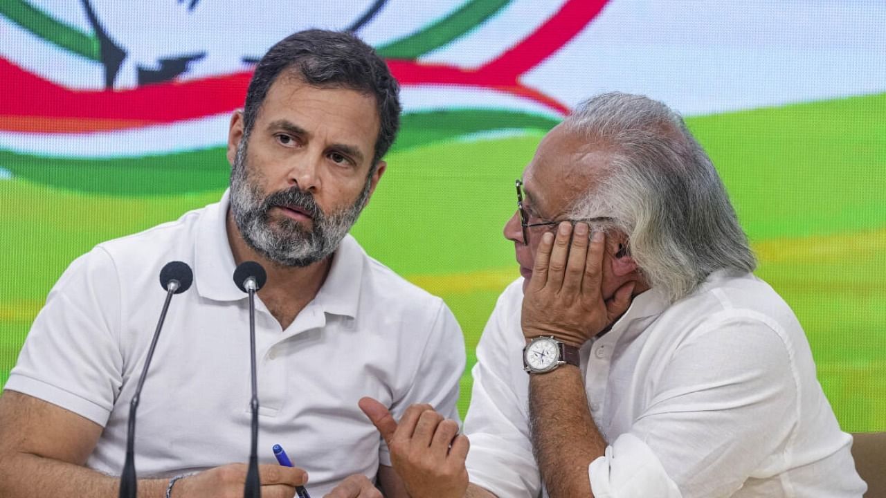 Congress leader Rahul Gandhi with party leader Jairam Ramesh during a press conference at AICC headquarters in New Delhi. Credit: PTI Photo