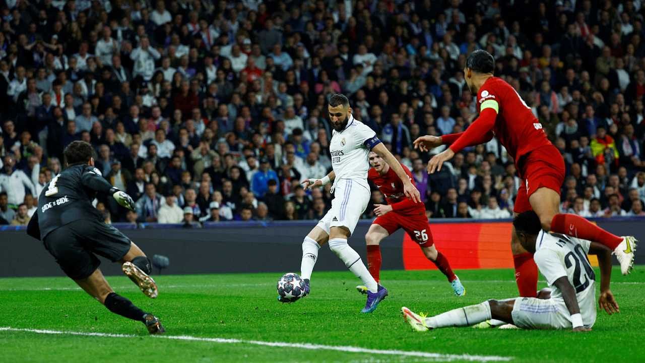 Real Madrid's Karim Benzema scores their first goal past Liverpool's Alisson. Credit: Reuters Photo