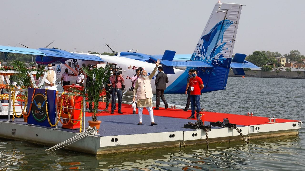 Prime Minister Narendra Modi waves to his supporters after he arrived from Kevadia via India’s first seaplane, at Sabarmati Riverfront in Ahmedabad, Saturday, Oct. 31, 2020. Credit: PTI File Photo