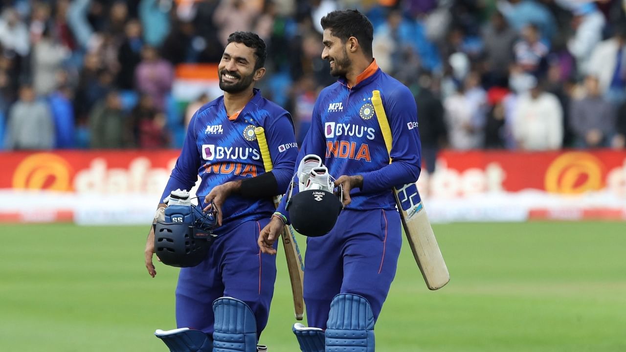 Dinesh Karthik (L) and Deepak Hooda (R) celebrate their win in the T20I cricket match between Ireland and India at Malahide cricket club, in Dublin on June 26, 2022. Credit: AFP File Photo
