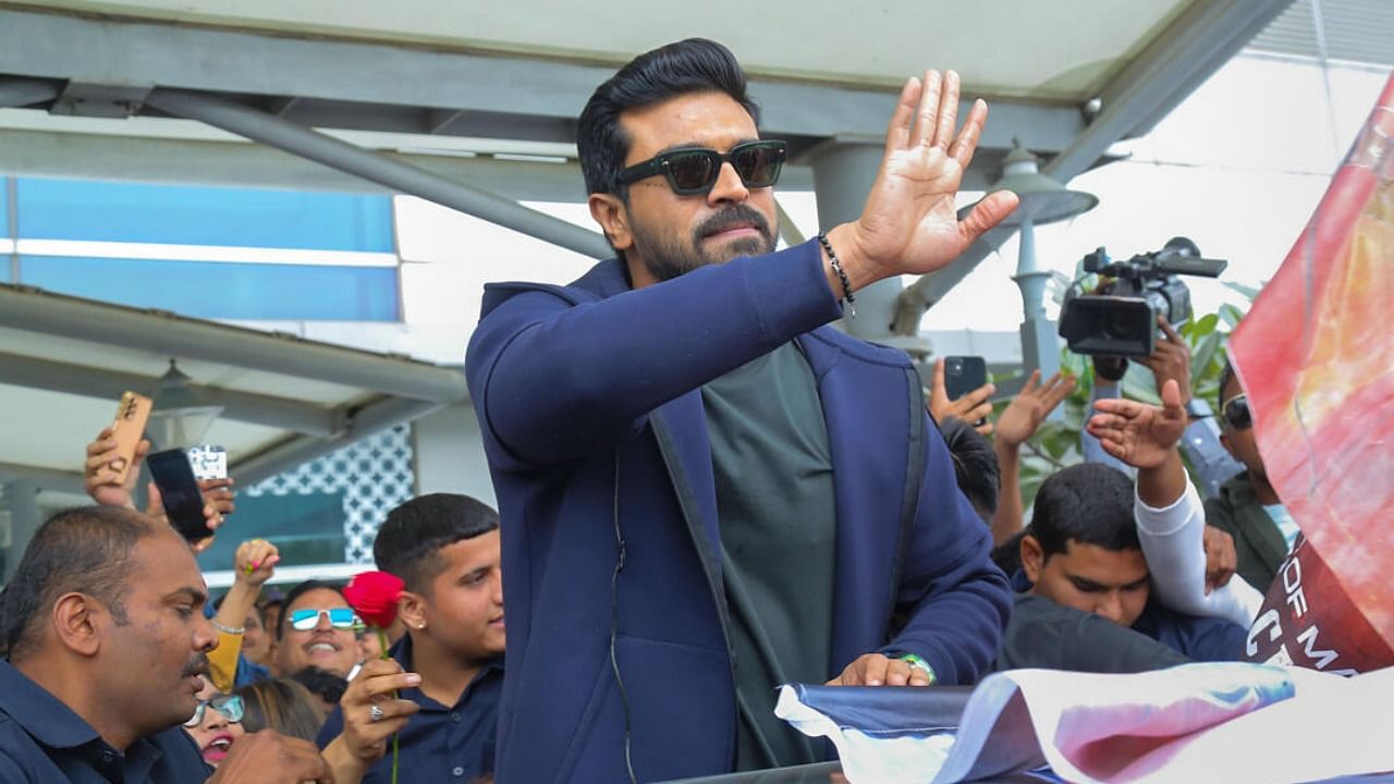 Actor Ram Charan being welcomed by fans on his arrival at the IGI Airport, in New Delhi. Credit: PTI Photo