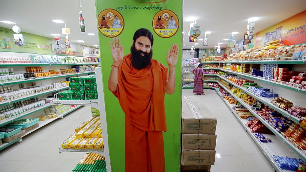 A hoarding with an image of Baba Ramdev is seen inside a Patanjali store. Credit: Reuters File Photo