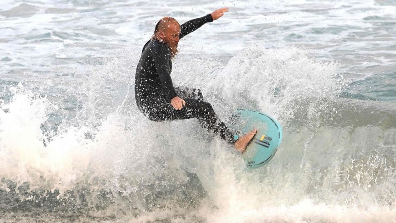 Blake Johnston surfs breaking the world record for the longest surfing session. Credit: AFP Photo