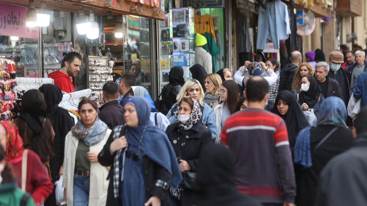 Iranian people walk at the Tajrish Bazaar, ahead of Nowruz, the Iranian New Year, in Tehran. Credit: Reuters Photo