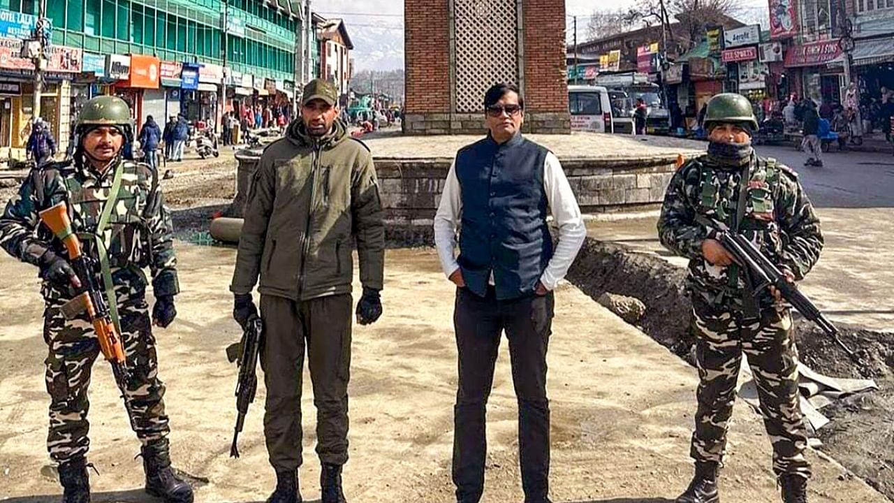 An undated photo of Kiran Patel with his security. Credit: PTI Photo