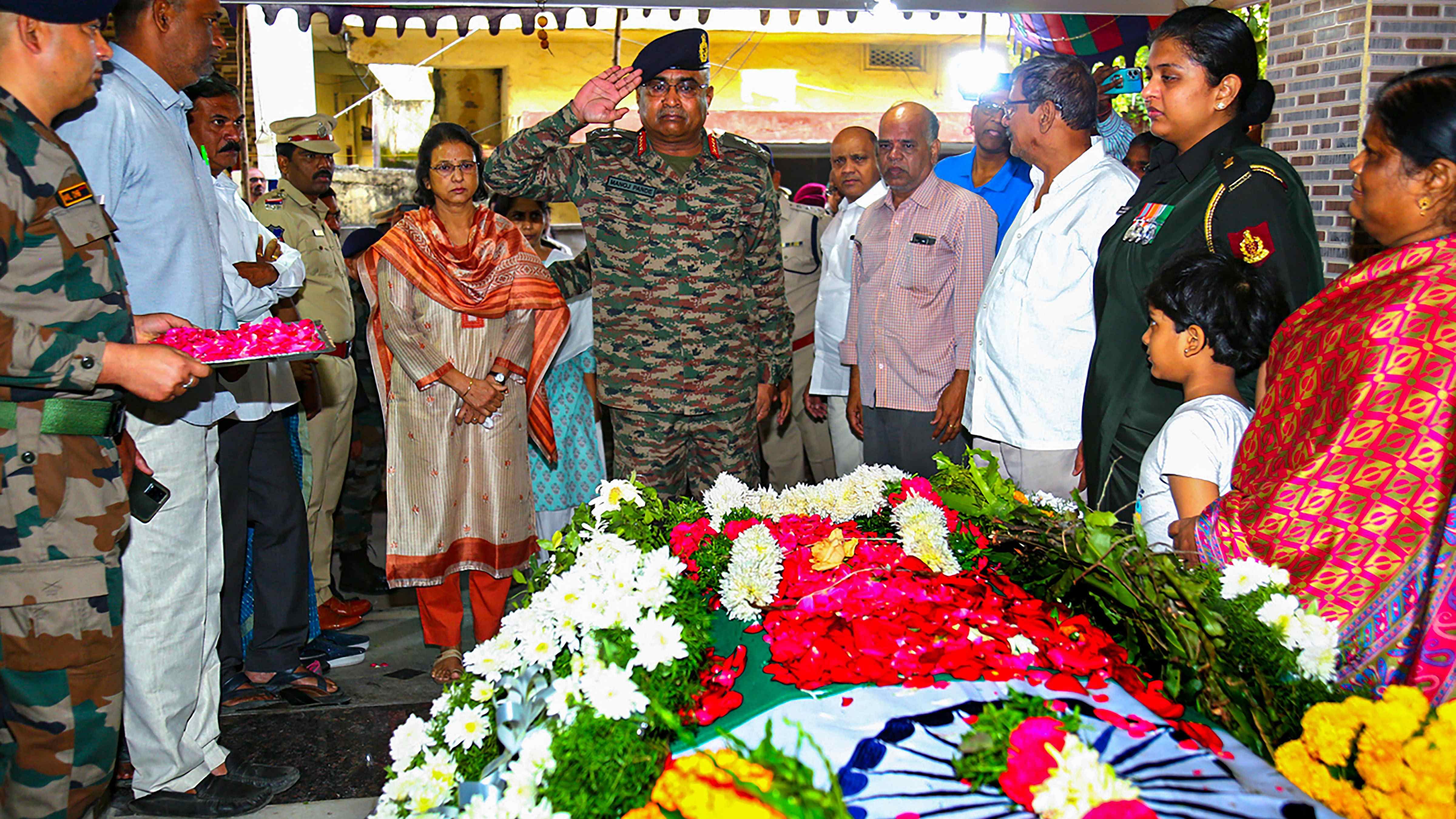 General Manoj Pande, Chief of the Army Staff, pays homage to late Lt Colonel VVB Reddy who lost his life in the line of duty, at his residence in Malkajgiri. Credit: PTI Photo