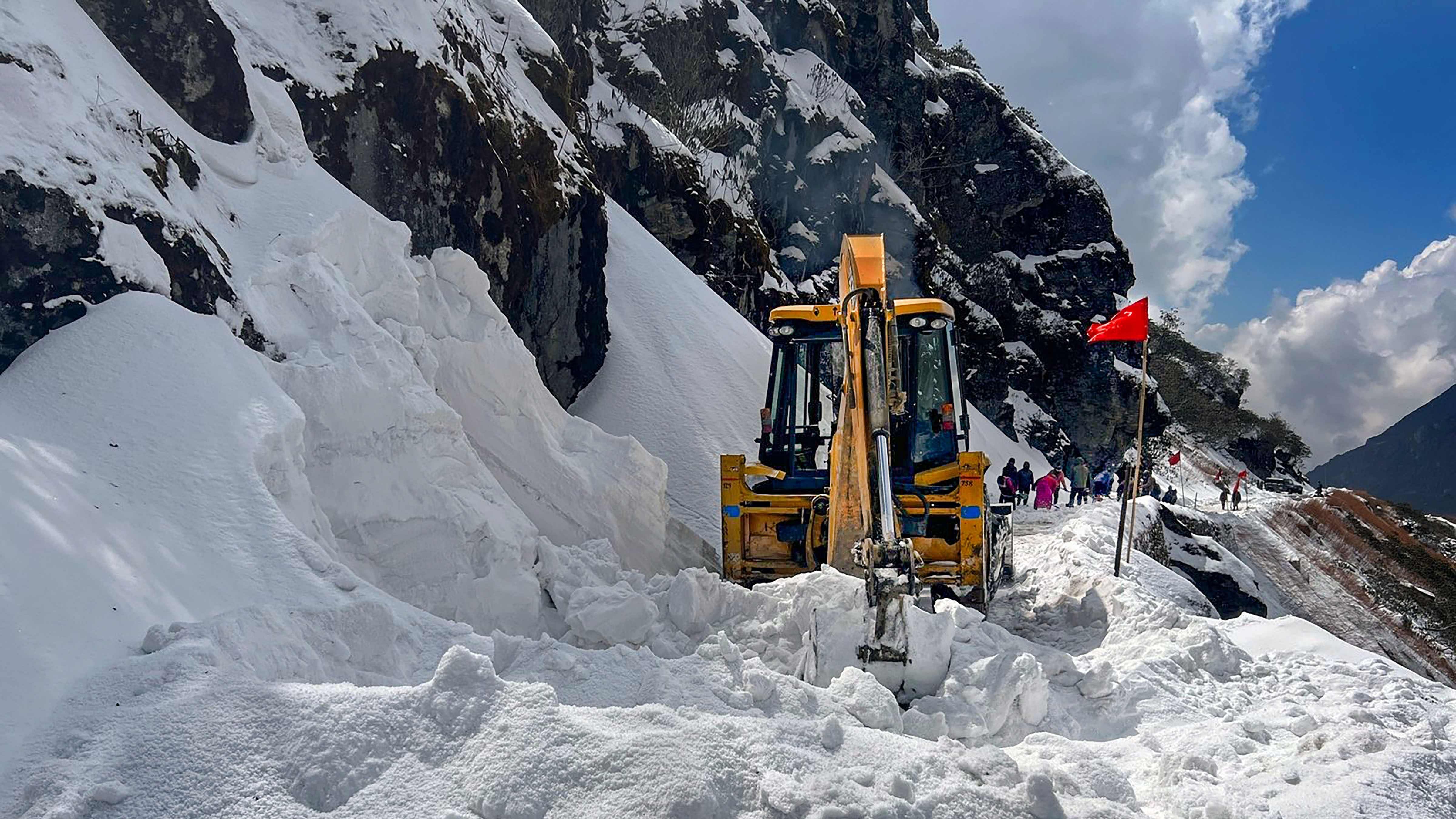 Border Road Organisation personnel clear the snow at Nathu La, in East Sikkim. Credit: PTI Photo
