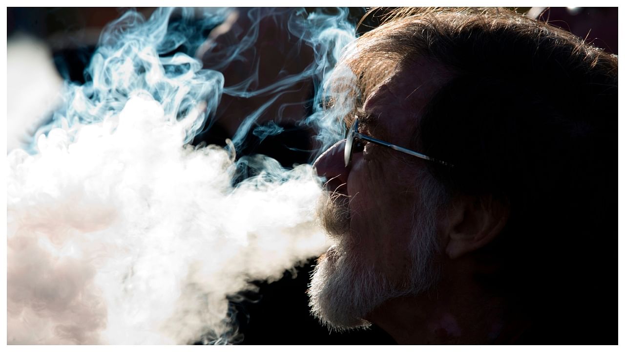 In this file photo taken on November 9, 2019 a demonstrator vapes during a consumer advocate groups and vape storeowners rally. Credit: AFP Photo