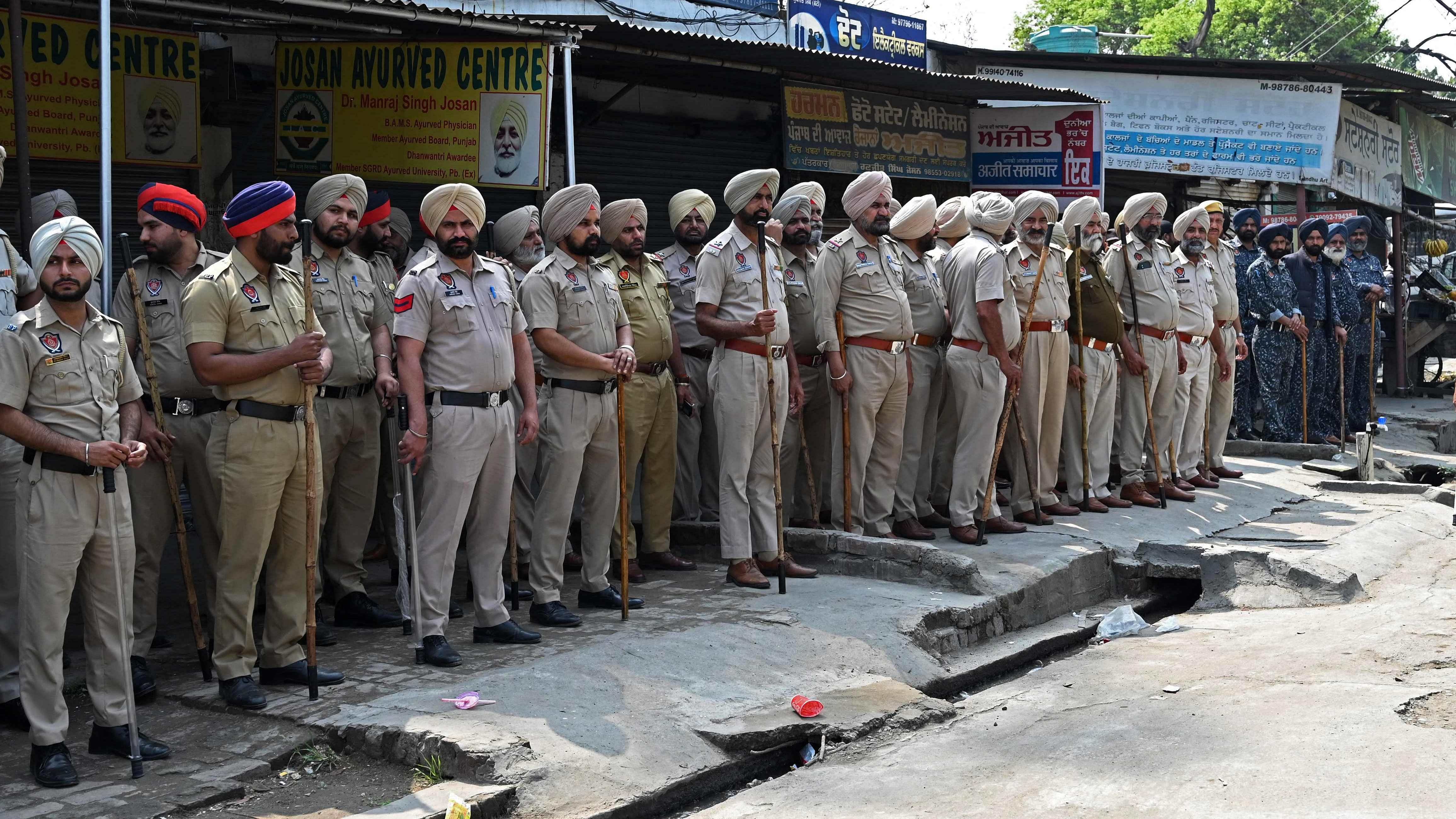 Police and security personnel stand guard in the village Jallupur Khera about 45 km from Amritsar on March 19, 2023. Credit: AFP Photo