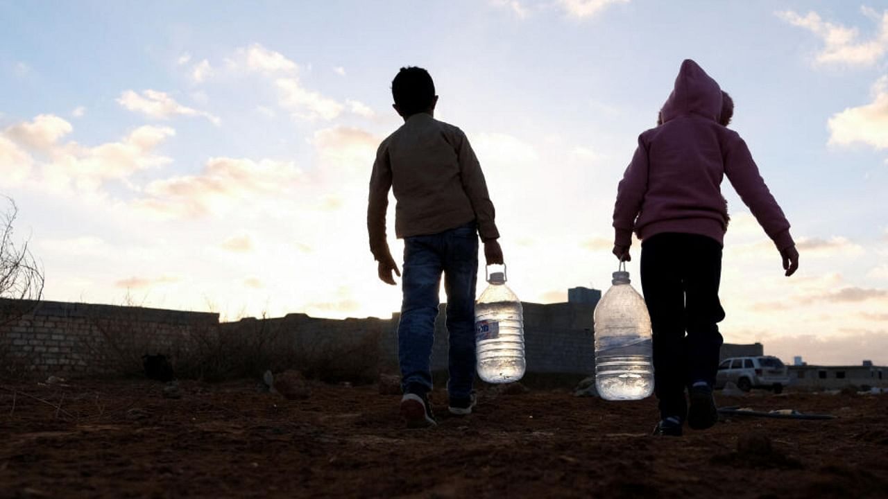 Children carry water bottles in Benghazi's Suluq area which experiences shortages in potable water. Credit: Reuters Photo