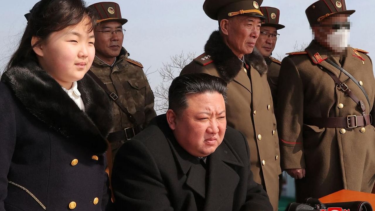 North Korea's leader Kim Jong Un (C) and his daughter (L) observing a warhead missile launch exercise simulating a tactical nuclear attack in Cheolsan county, North Pyongan Province. Credit: AFP Photo/KCNA via KNS