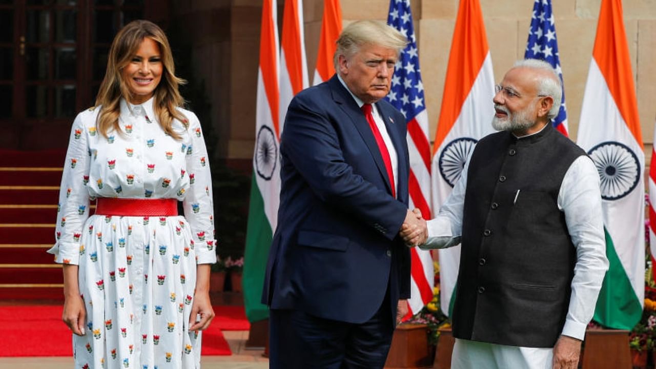 Prime Minister Narendra Modi with former US president Donald Trump and wife Melania Trump. Credit: Reuters File Photo