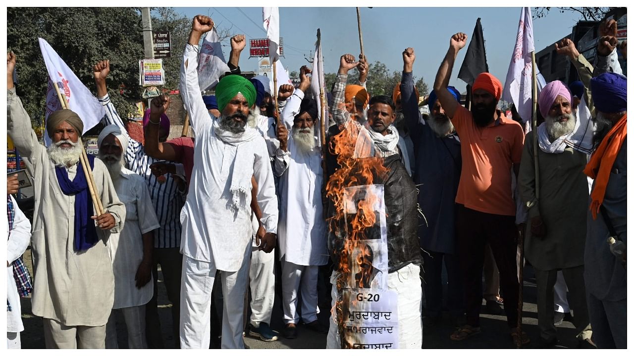 Farmers shout slogans as they burn effigies of Narendra Modi and Punjab CM Bhagwant Mann during a protest to demand a farm debt waiver, pending payments of sugarcane farmers & MSP on March 14, 2023, Credit: AFP Photo