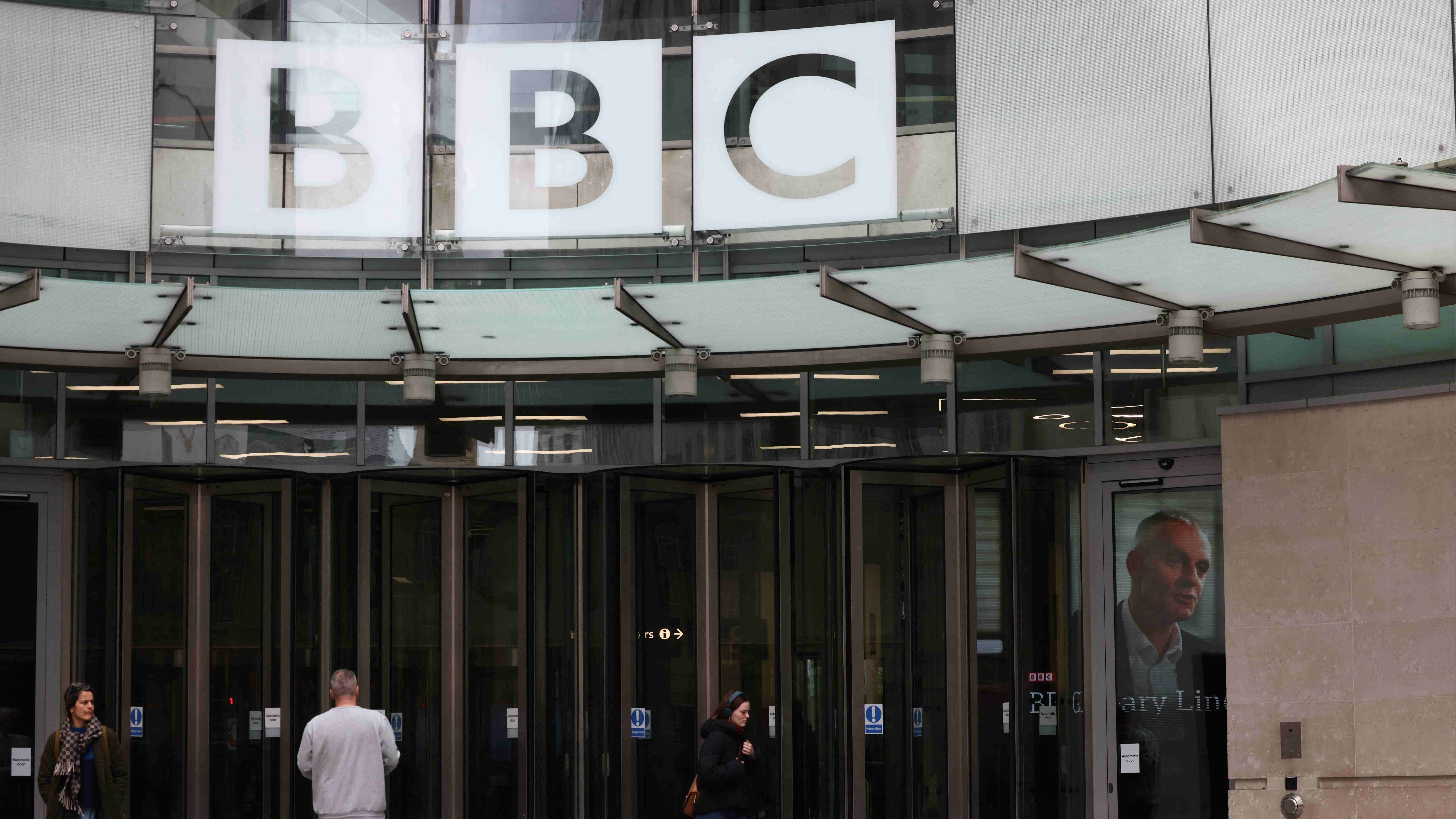 An image of British Broadcasting Corporation (BBC) Director-General Tim Davie is seen through the door at the BBC headquarters in London. Credit: Reuters Photo