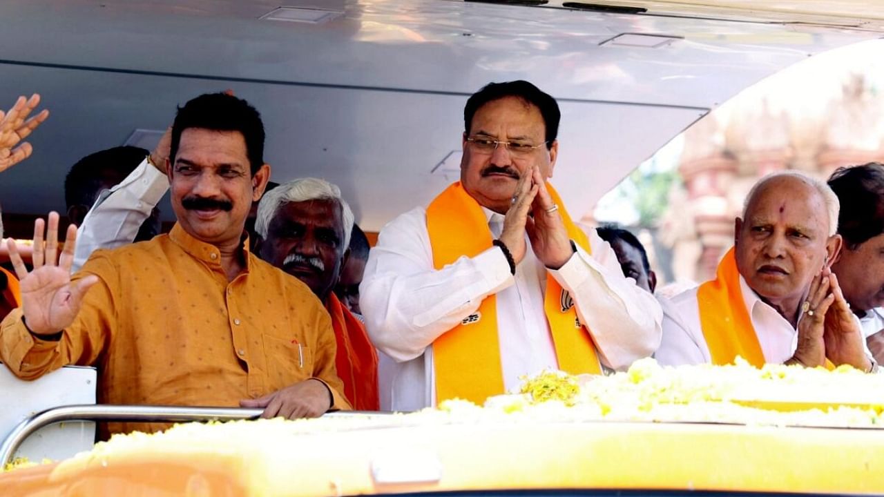 BJP National President JP Nadda (C), former Karnataka CM BS Yediyurappa (R) and Karnataka party President Nalin Kumar Kateel in poll-bound Karnataka. Credit: PTI Photo