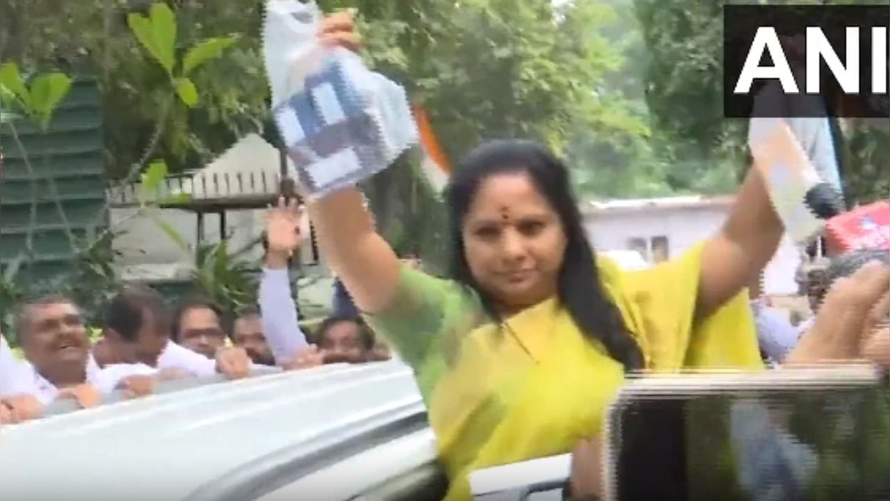 K Kavitha outside KCR's house displaying mobile phones she used during scam period. Credit: Twitter / @ANI